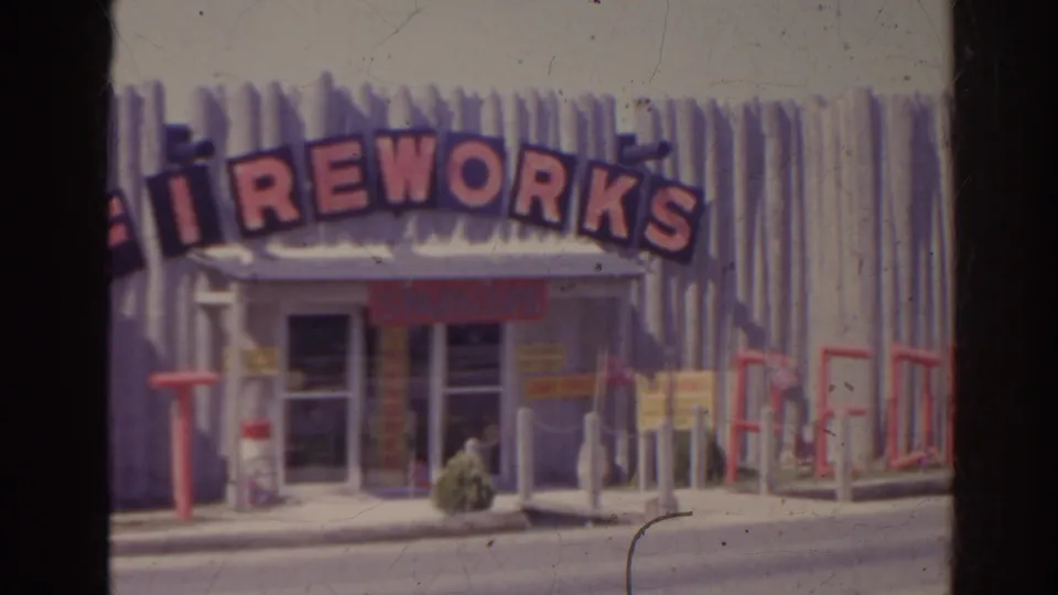 1962 Florida home-movie view of the fireworks shop as a car begins to pass in front of the storefront.