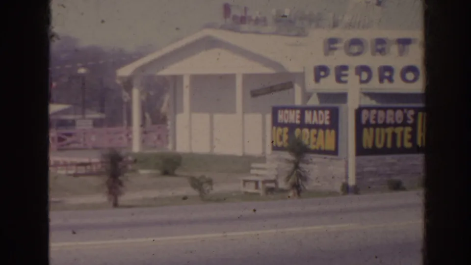 1962 Florida frame showing Fort Pedro signage, a small pavilion, palm plantings, and boards advertising home made ice cream and Pedro's Nutte House.