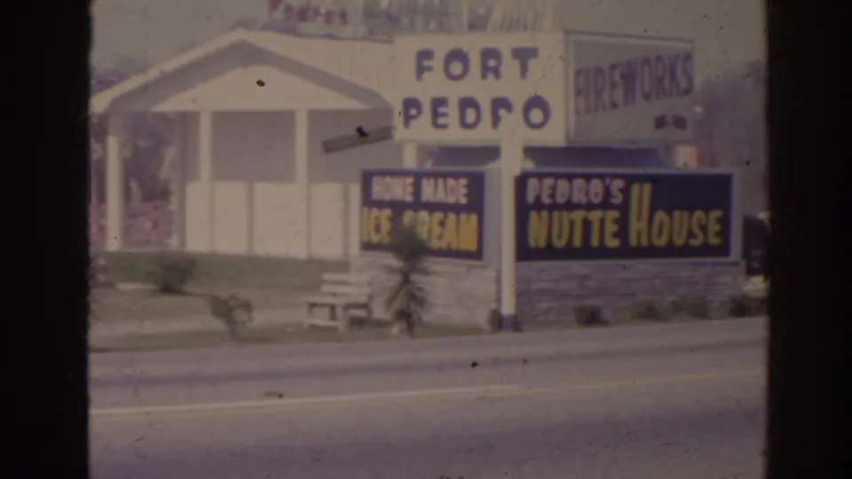 1962 Florida 8mm frame of Fort Pedro roadside signage, including FIREWORKS, home made ice cream, and Pedro's Nutte House boards.