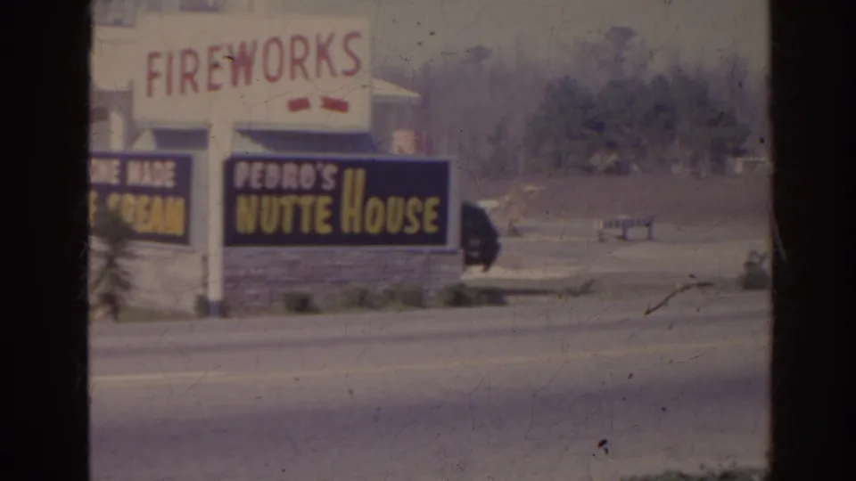 1962 Florida roadside business signs for Fort Pedro Fireworks, Home Made Ice Cream, and Pedro's Nutte House on faded 8mm film.