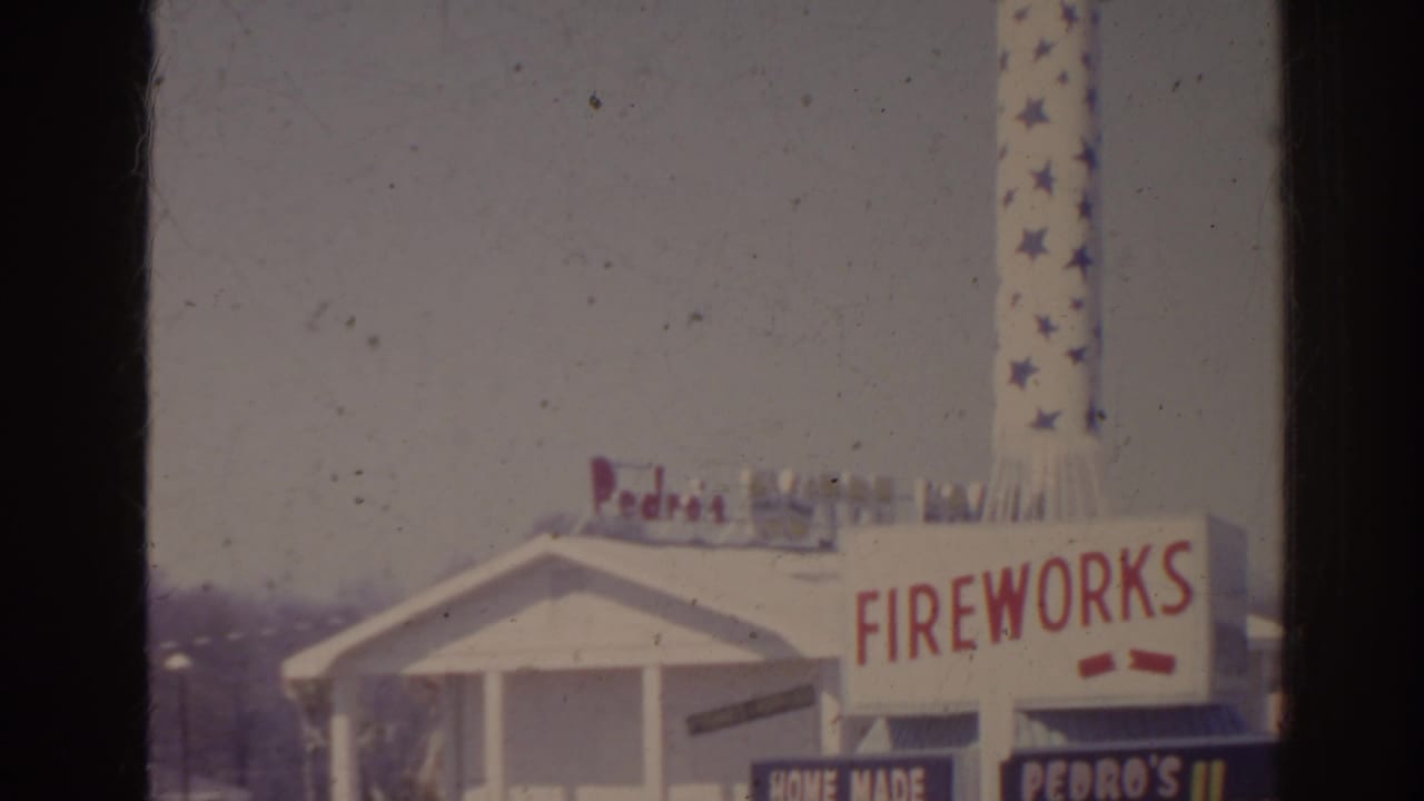 White roadside building with Fireworks sign and star-patterned rotating tower.