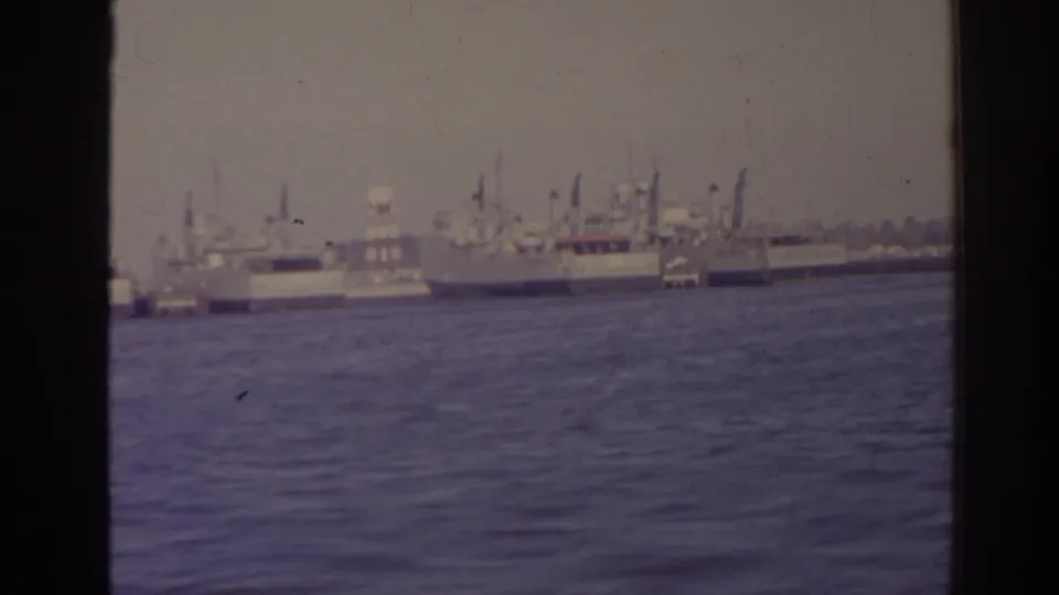 1962 Florida frame showing ships gathered near a waterfront, with open water and film borders visible.
