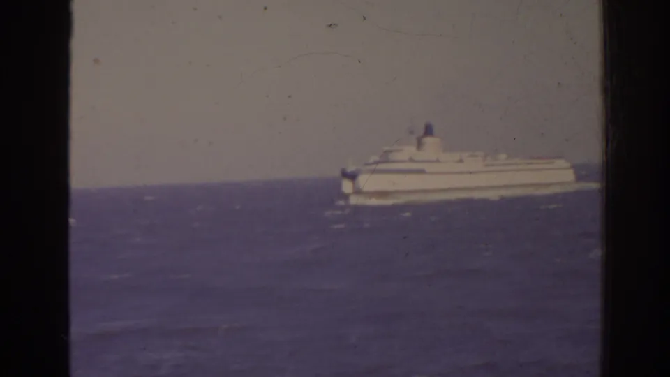 Faded 8mm view of a white passenger ship or ferry off Florida, seen across rough sea in 1962 footage.