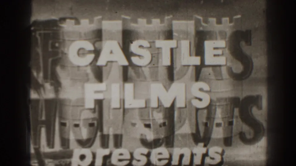Black-and-white 8mm title card for Castle Films Presents, with bold lettering, castle motif, grain, and visible frame wear.