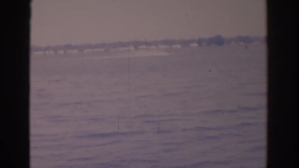 Faded 8mm waterfront view from 1962 Florida, showing open water and an indistinct far shore.