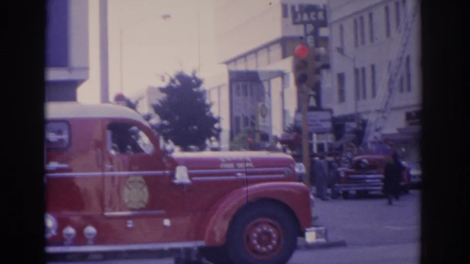 1962 Florida street view with a red fire truck, visible Jack Pendola signage, traffic signals, and mid-century buildings.