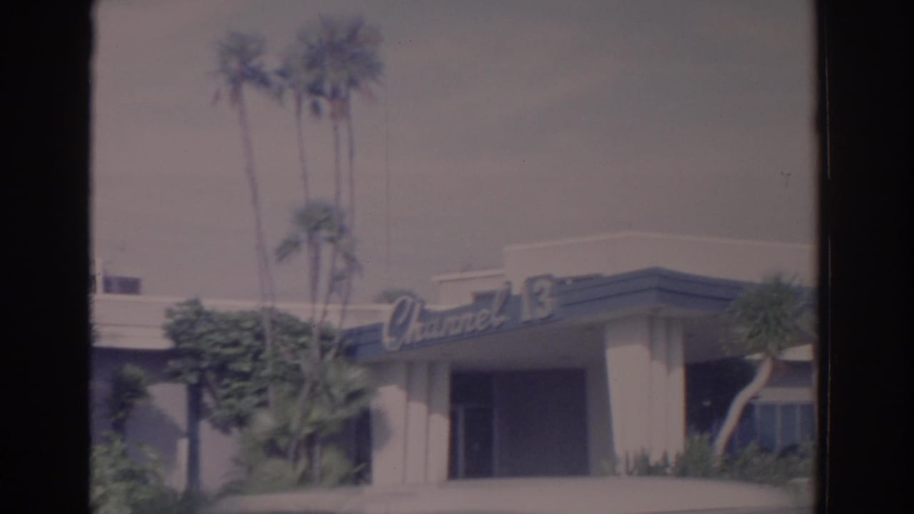 Channel 13 building exterior with palm trees and a dark film-strip border.