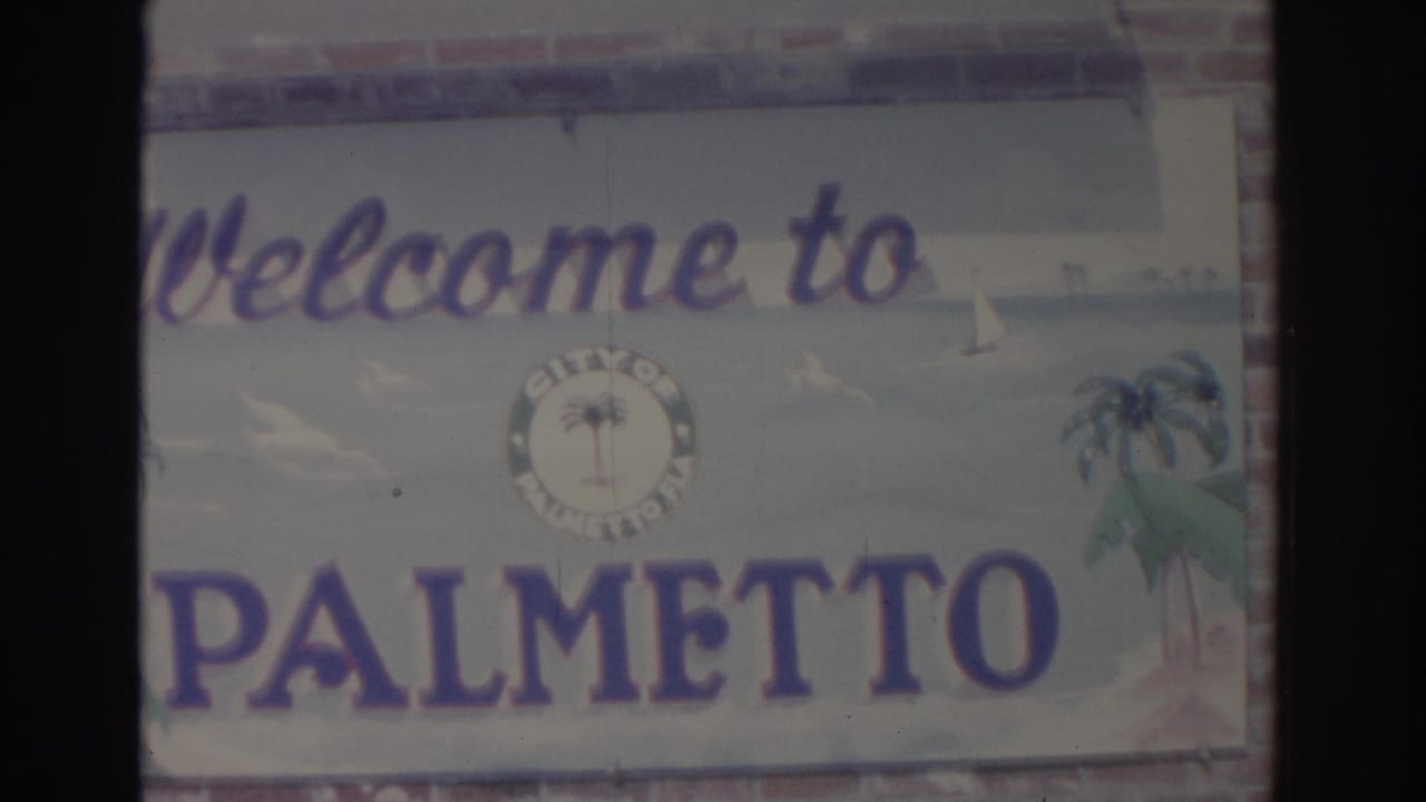 Weathered Welcome to Palmetto sign with palm graphics and a city seal.