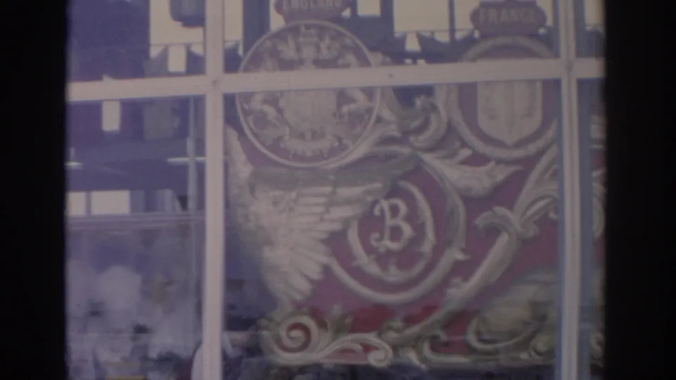 1962 Florida 8mm frame showing an ornate decorative crest or emblem viewed through window panes, with a prominent letter B.
