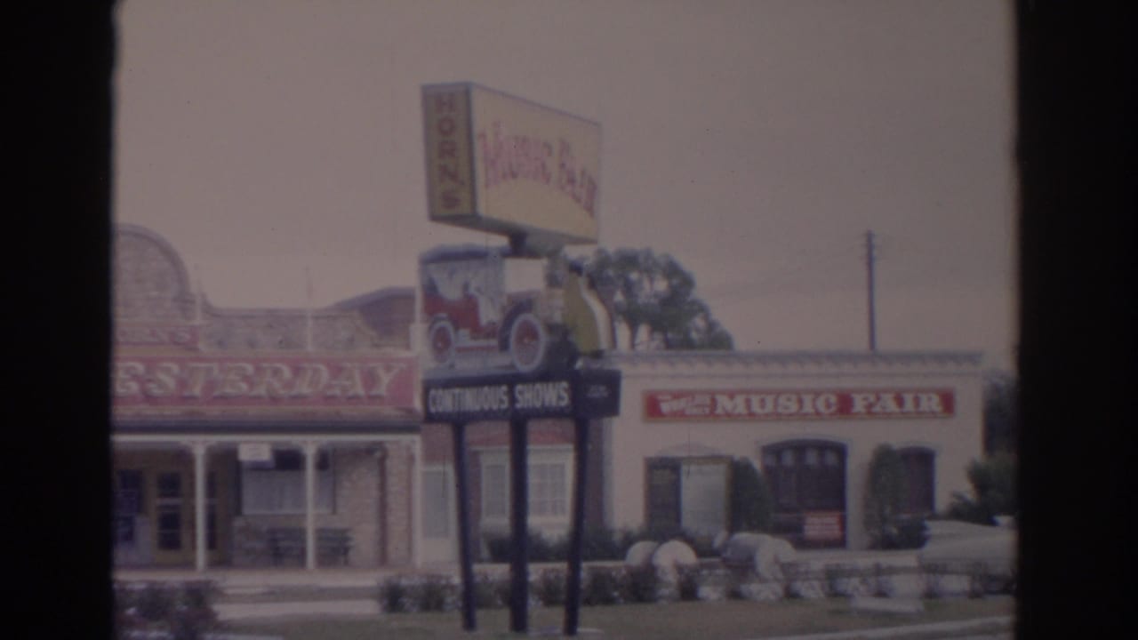 1962 Florida travel footage frame with the Music Fair sign, classic car graphic, and Cars of Yesterday facade in bright daylight.