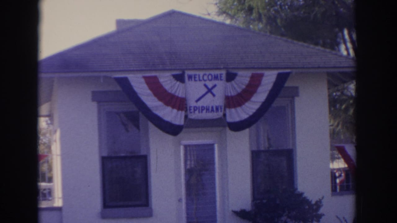 Final 1962 Florida frame showing the same decorated building with bunting, windows, and the WELCOME EPIPHANY sign.