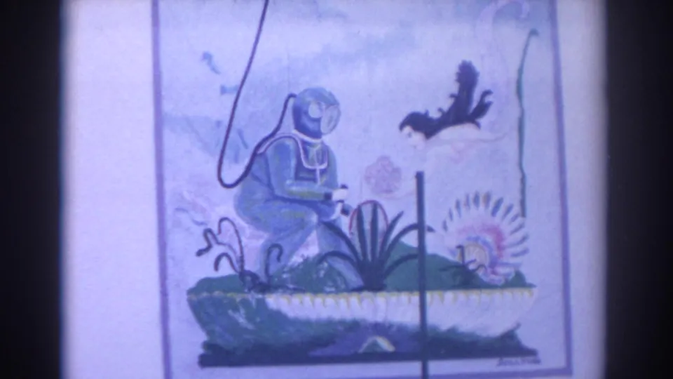 1962 Florida frame showing colorful marine art of a scuba diver, fish, sea plants, and a shell, filmed on 8mm.