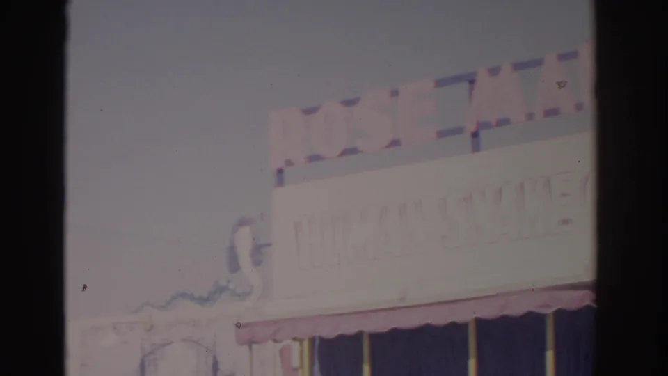 A bright final frame shows partial amusement signage, an awning, and washed-out sky in the same 1962 Florida fair footage.