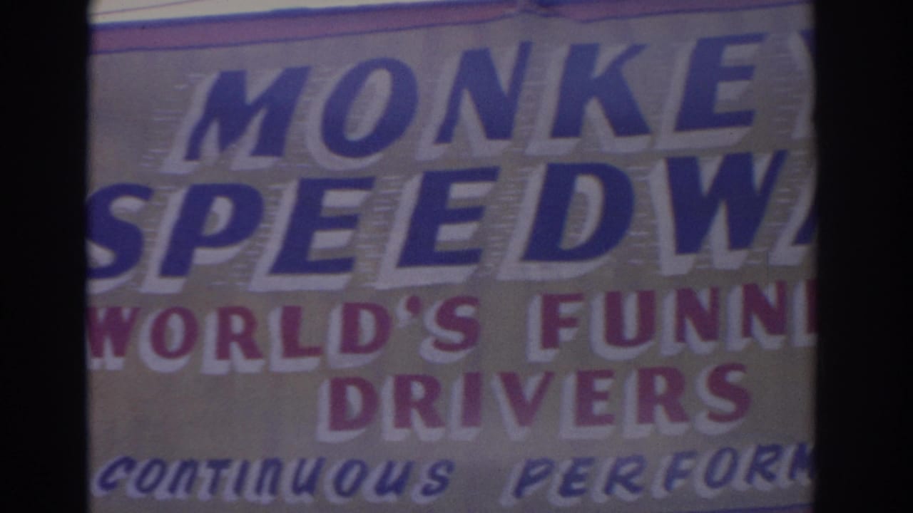 1962 Florida 8mm frame showing the upper right portion of the Monkey Speedway sign and World's Funniest Drivers wording.