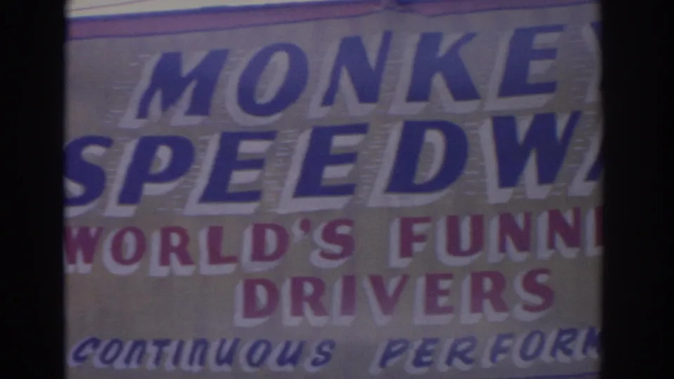 1962 Florida 8mm frame showing the upper right portion of the Monkey Speedway sign and World's Funniest Drivers wording.