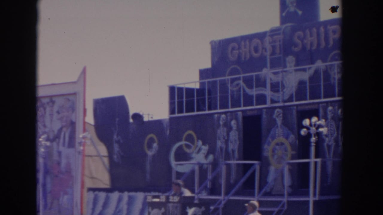 1962 Florida fairground view of the Ghost Ship ride, showing a dark boat-like facade, sign lettering and skeletal artwork.