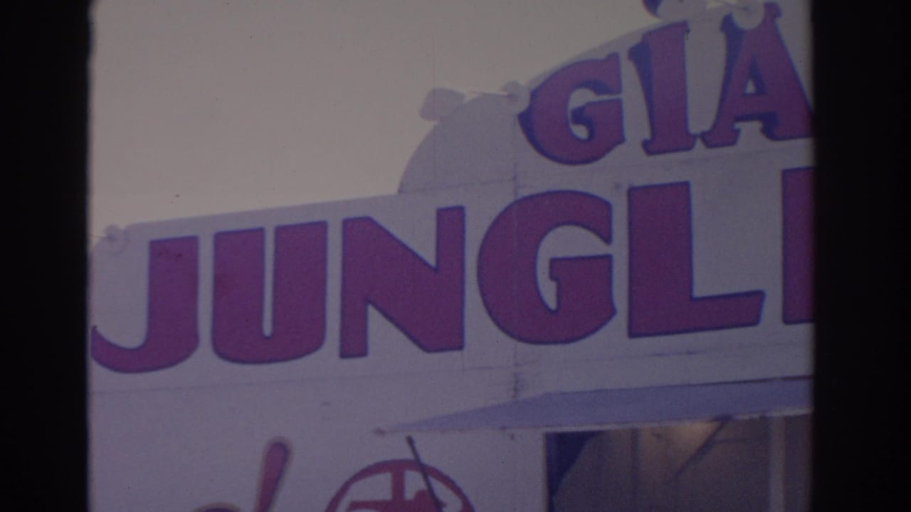 1962 Florida 8mm close-up of large Giant Jungle lettering on a carnival facade, with part of a lower entrance or tent opening visible.