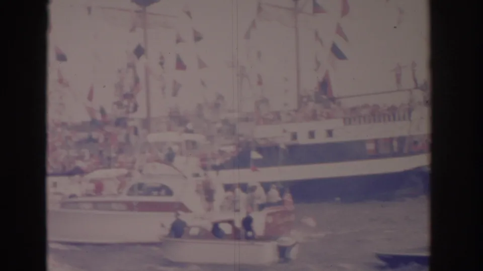 The final frame shows the decorated ship partly obscured by small boats as spectators watch from decks and the water.