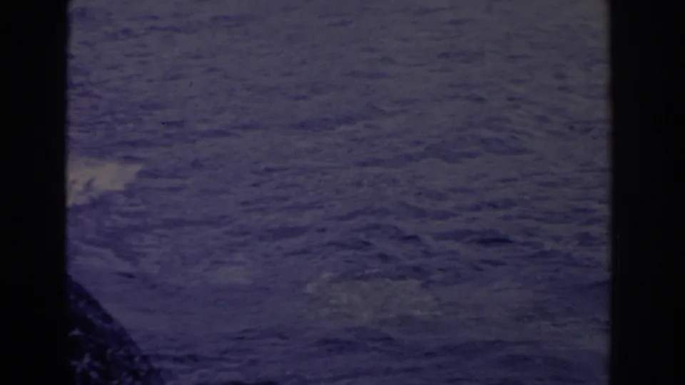 Open Florida water in a 1962 home-movie frame, with ripples, soft exposure, and a dark film or boat edge at lower left.