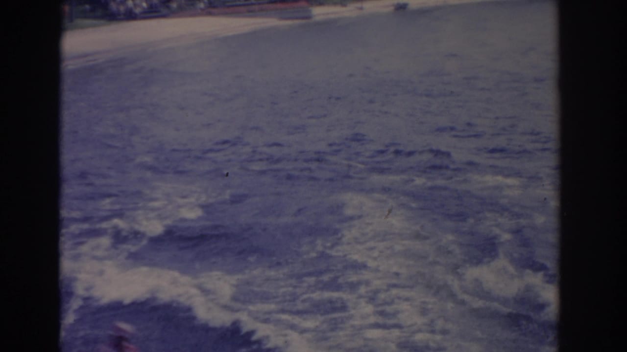 Soft 8mm frame showing foamy wake and disturbed water during a Florida water-sports run.