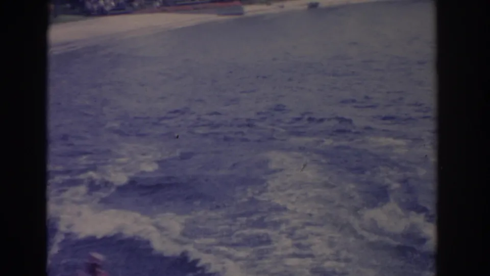 Soft 8mm frame showing foamy wake and disturbed water during a Florida water-sports run.