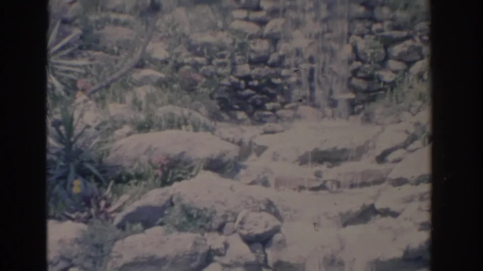 The South Sea Waterfall appears as water running down a constructed stone wall and over rocks at Florida Cypress Gardens.