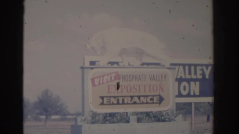 1962 Florida 8mm frame showing the Phosphate Valley Exposition entrance sign with a white bear figure above it.