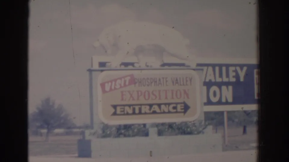 1962 Florida home-movie frame of the Phosphate Valley Exposition entrance sign, partially cropped at the right edge.