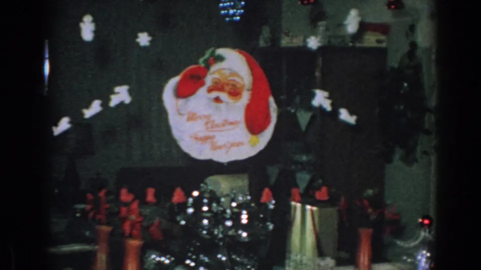 1962 Gary, Indiana frame showing a silver Christmas tree, Santa face topper, and red poinsettia-like decorations.