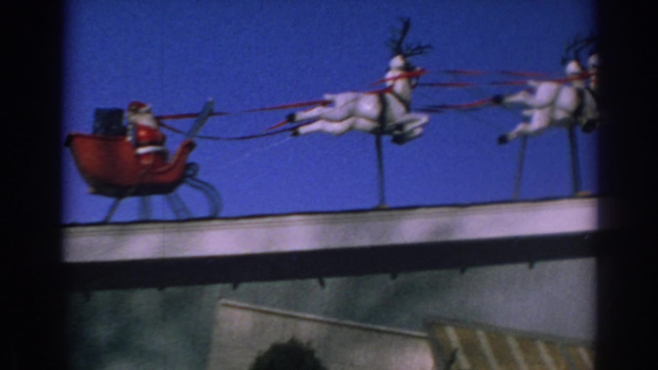 Santa sleigh and multiple white reindeer figures stretch across a rooftop display.