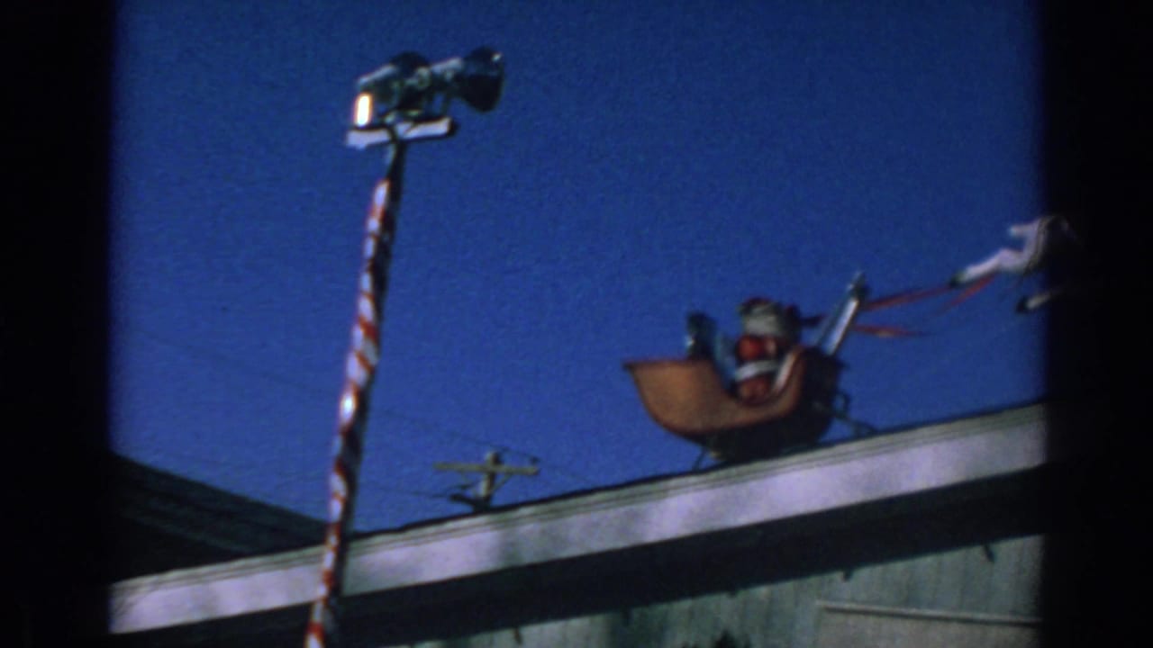 Rooftop Santa sleigh decoration under a clear blue sky.