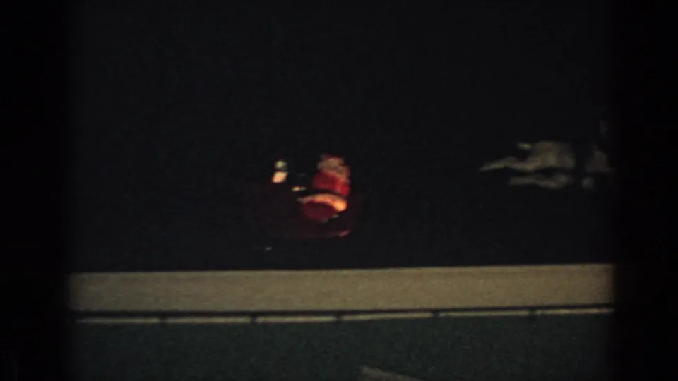 1962 Gary, Indiana frame with a faint glowing Santa sleigh figure above a dark roofline at night.