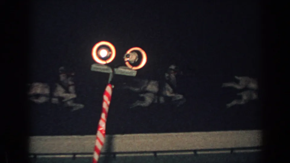 1962 Gary, Indiana frame with rooftop reindeer silhouettes, twin circular lights, and a striped pole against a dark night sky.