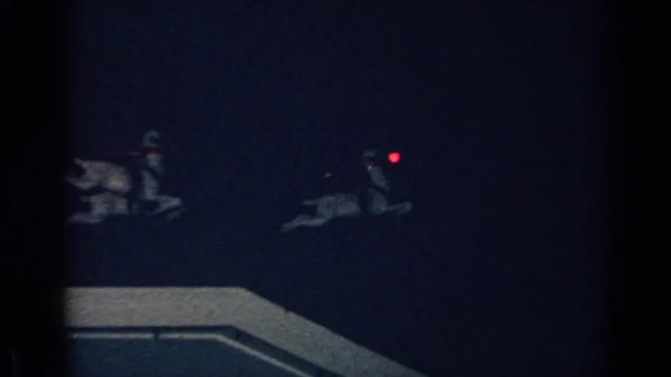 Final 1962 Gary, Indiana frame showing part of the rooftop display, including reindeer figures and a small red glowing nose or eye light.