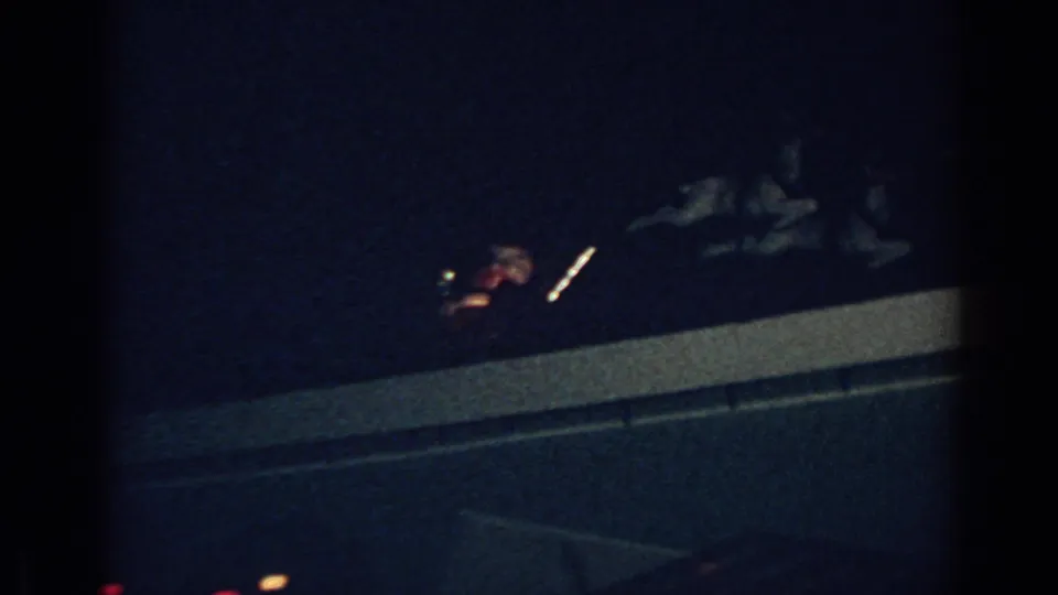 1962 Gary, Indiana frame with an illuminated Santa sleigh and reindeer decoration seen against a dark night sky.