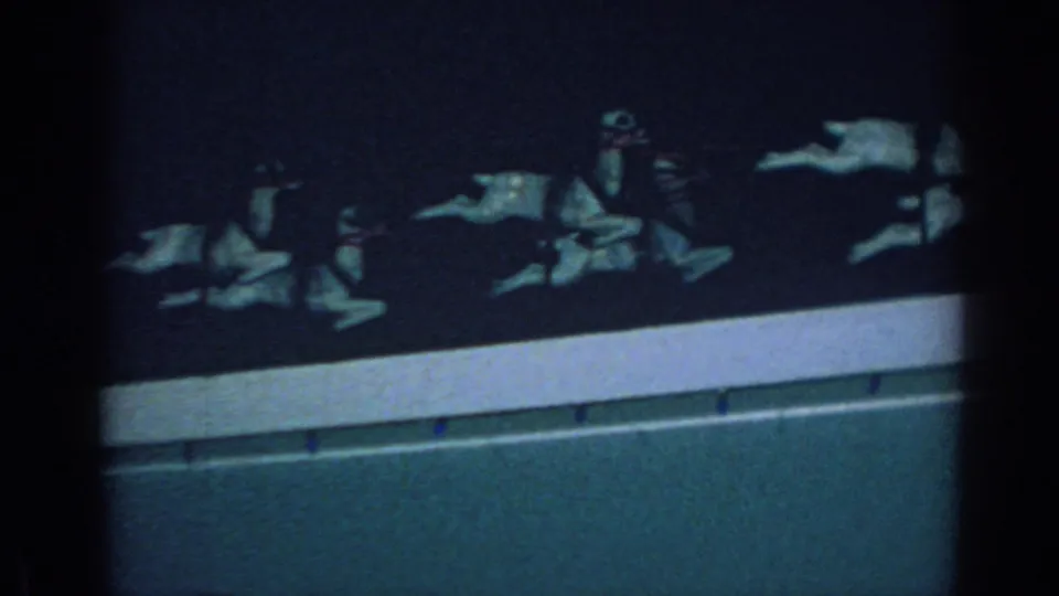1962 Gary, Indiana frame showing a nighttime row of reindeer and sleigh decorations above a pale exterior edge.