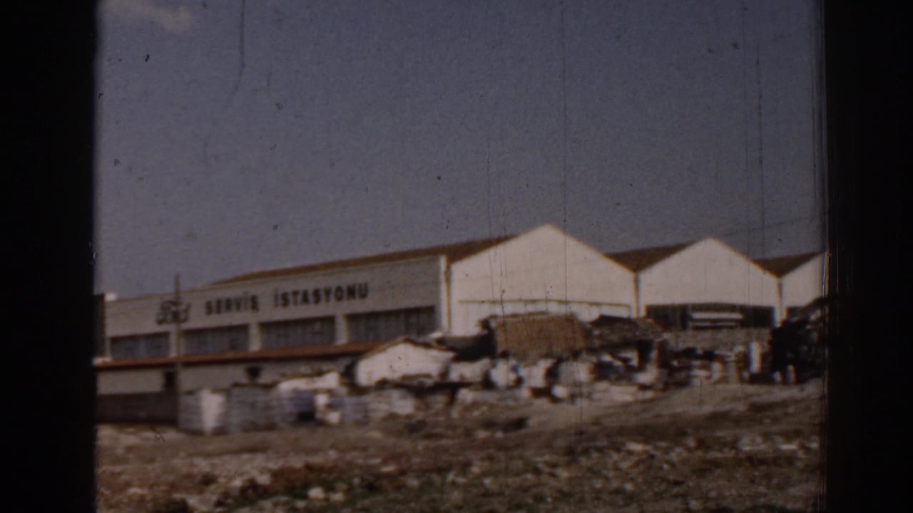 Ford service station facade with Turkish sign and scattered roadside materials.
