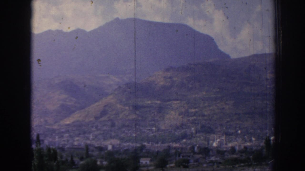 Mountain ridge and hillside city area seen from a high overlook.