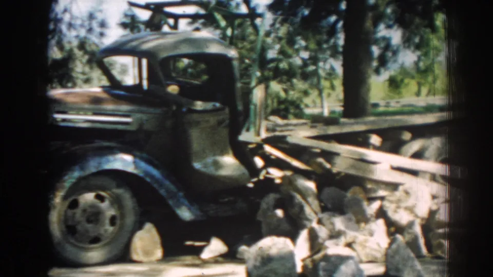 Closer 1962 Izmir frame of the truck cab and flatbed, with wooden planks and stones filling the foreground after the apparent collision.