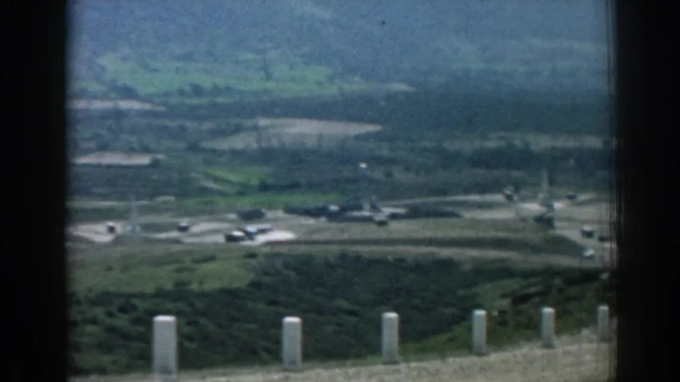 The final frame holds on a distant Izmir-area valley with foreground posts, roads, fields, and pale aircraft-like shapes.