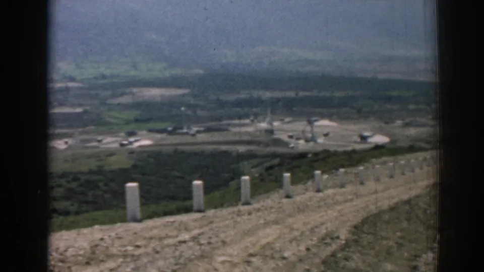 Izmir, Turkey, 1962 view from a hillside road toward an open building project, with muted 8mm color and grain.