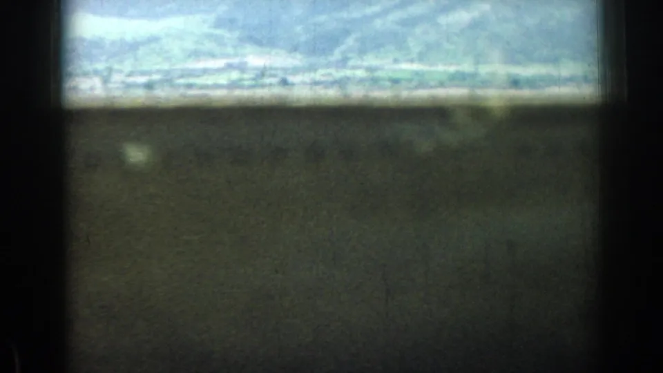 The final frame becomes mostly dark and out of focus, with only a bright band of hillside landscape visible near the top.