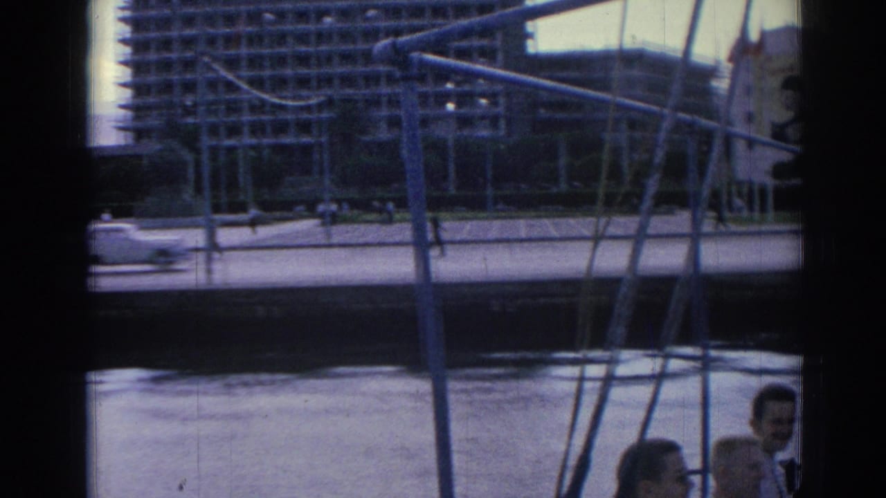From a tour boat in Izmir, rigging frames the waterfront and a large modern building beyond the promenade.