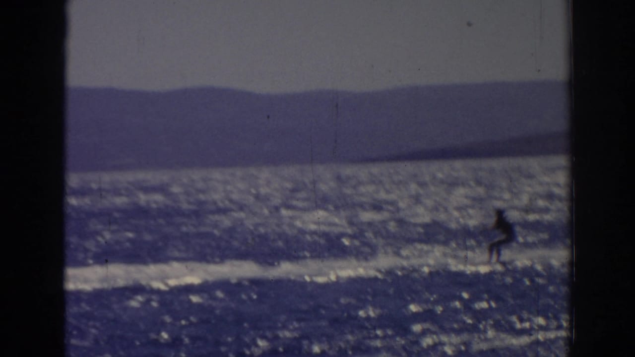 Distant water skier in the 1962 Izmir footage glides near the right side of the frame with a long wake behind.