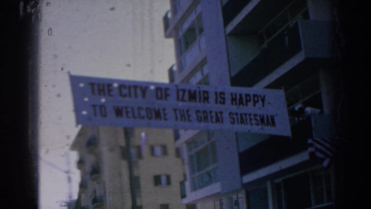 1962 Izmir street banner stretched near apartment buildings, welcoming a great statesman in bold lettering.