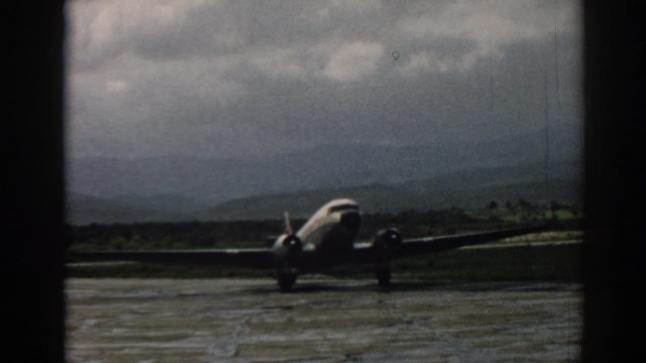 1962 Izmir airport footage showing a front-facing propeller aircraft on the tarmac against distant mountains.