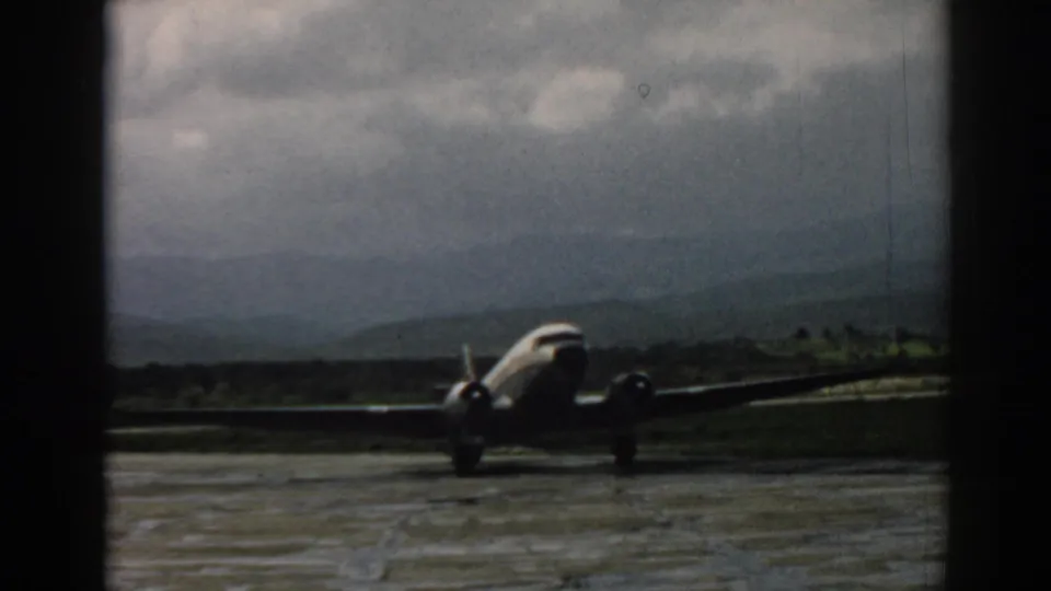 1962 Izmir airport footage showing a front-facing propeller aircraft on the tarmac against distant mountains.