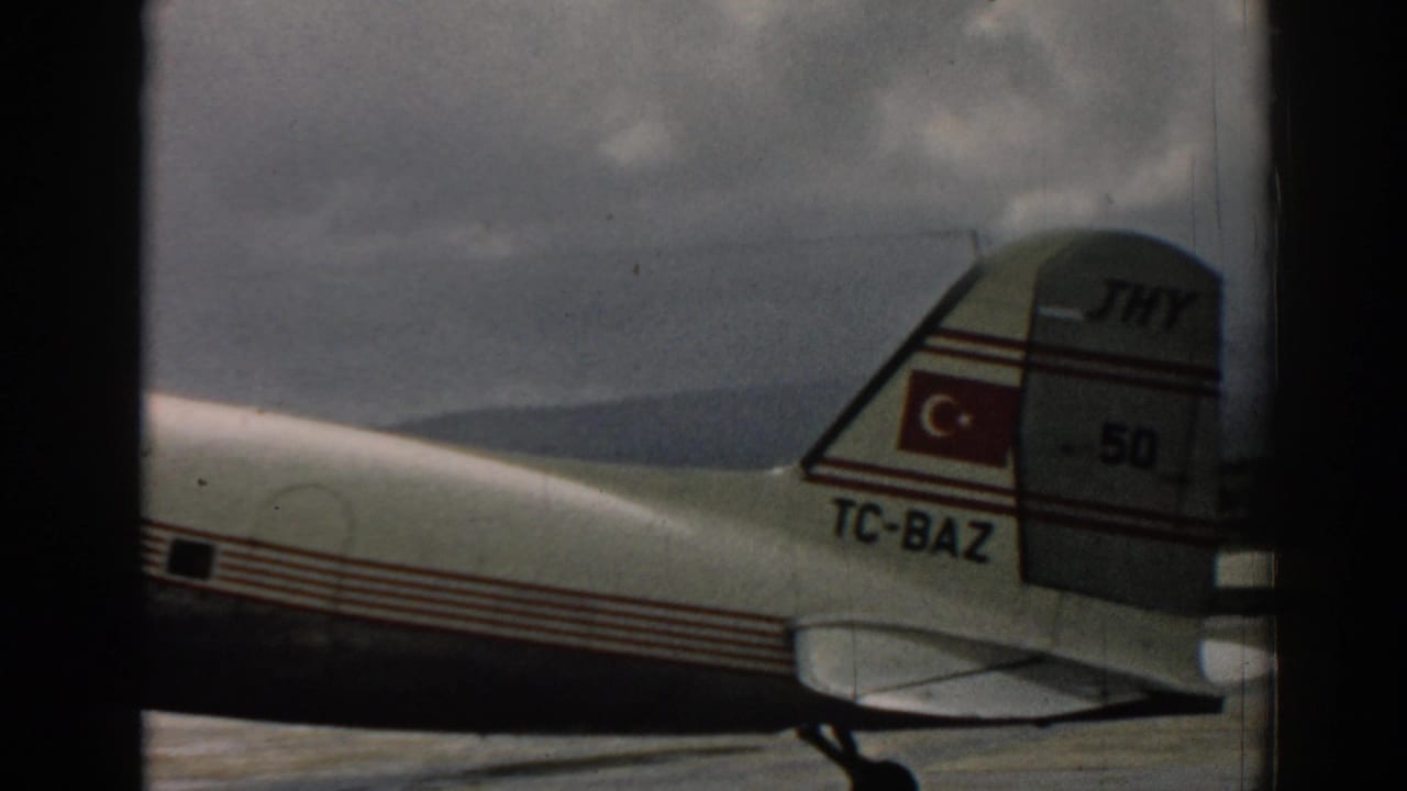 The tail of the Turkish Airlines aircraft shows the Turkish flag and TC-BAZ registration in the Izmir 1962 runway scene.