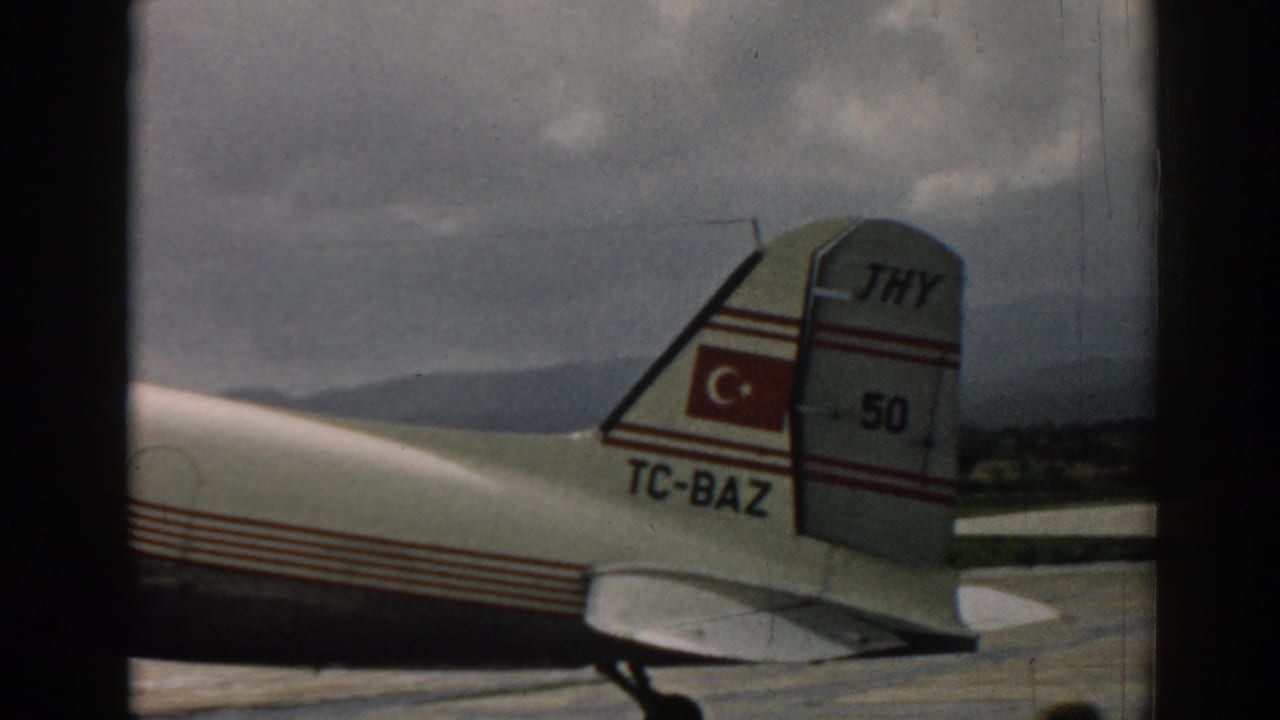 THY aircraft tail with Turkish flag and TC-BAZ marking on a tarmac.