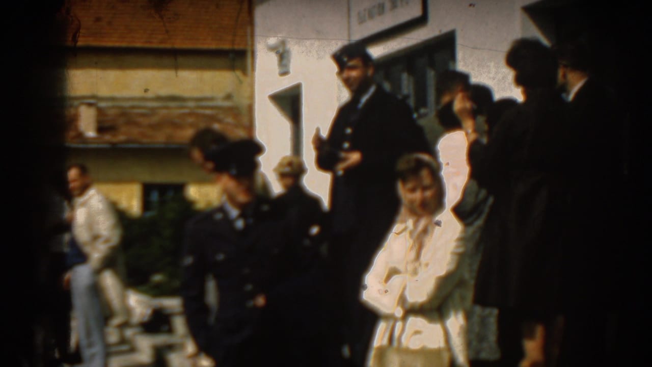 People gather near an Izmir airport building in 1962, including uniformed men and civilians watching an arrival.